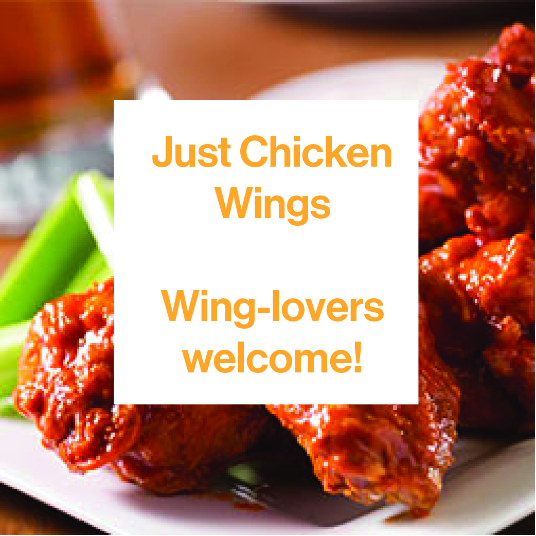 Crispy, golden chicken wings with a big bowl of spicy hot sauce