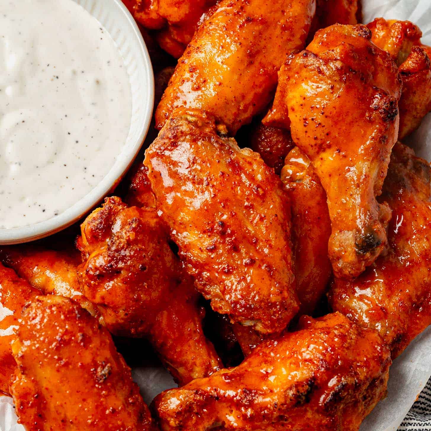 Saucy, spicy, delicious chicken wings with a big bowl of ranch